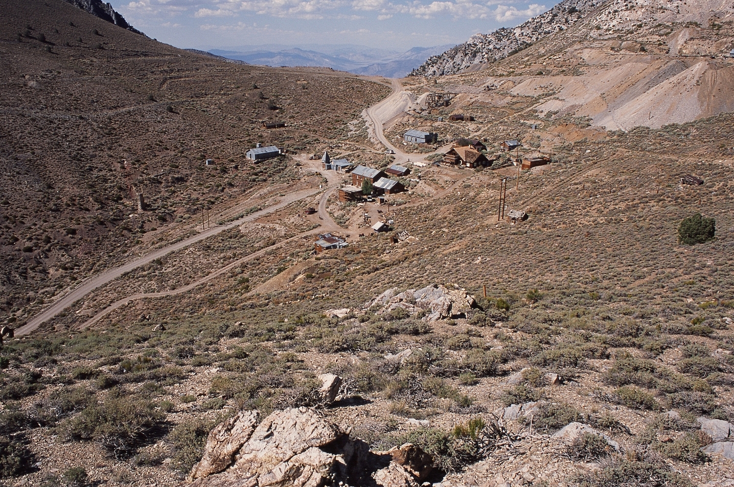 Cerro Gordo ghost town California — panoramic view of the silver mining camp in the Inyo Mountains with Saline Valley visible in the distance