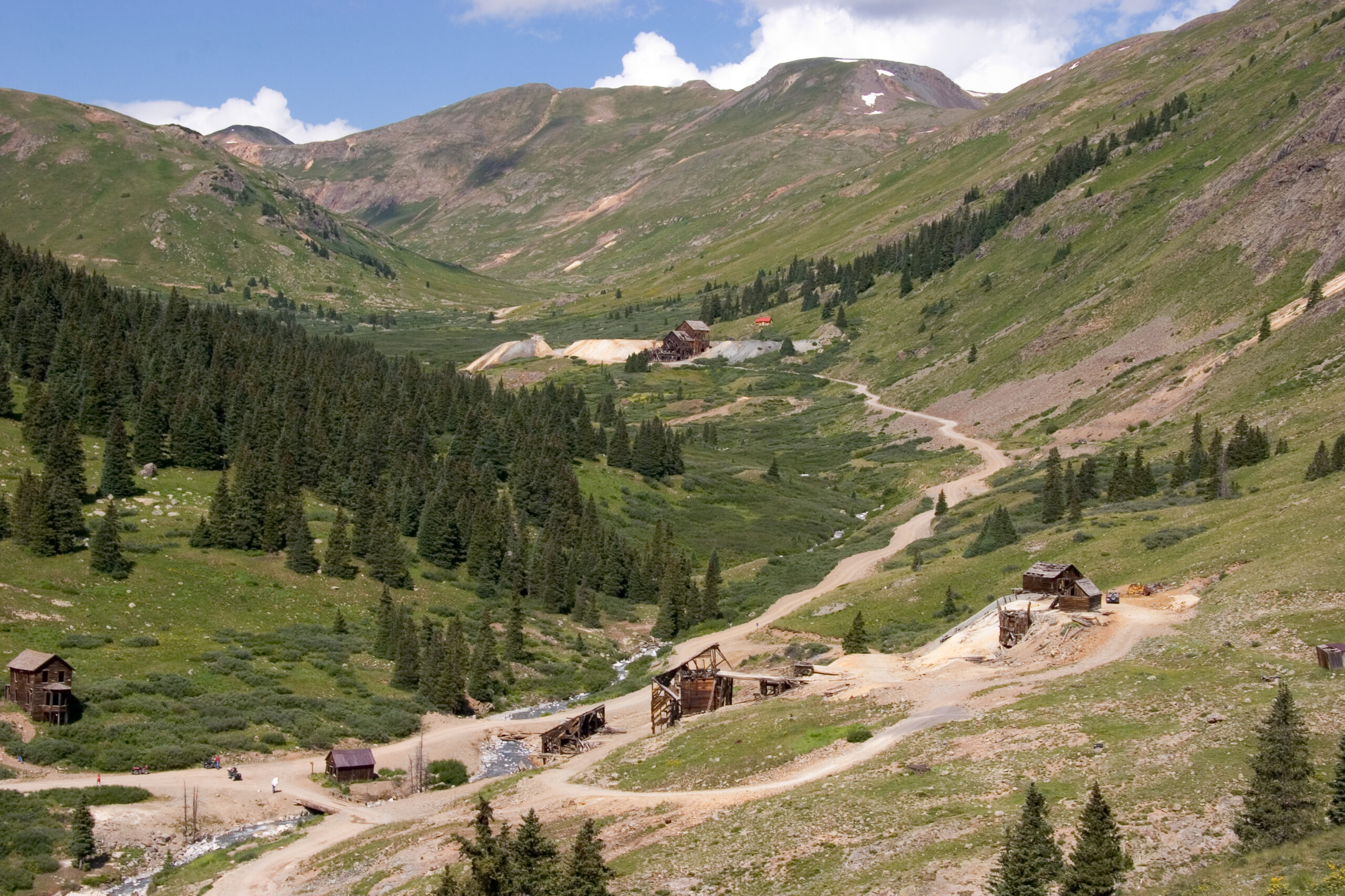 Weathered wooden buildings of the Animas Forks ghost town in a high alpine valley in the San Juan Mountains of Colorado