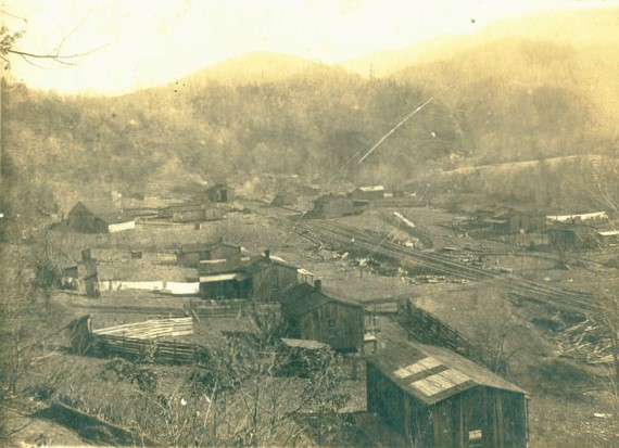 A black-and-white photograph of Elkmont, Tennessee around 1915 showing logging-era buildings in the valley