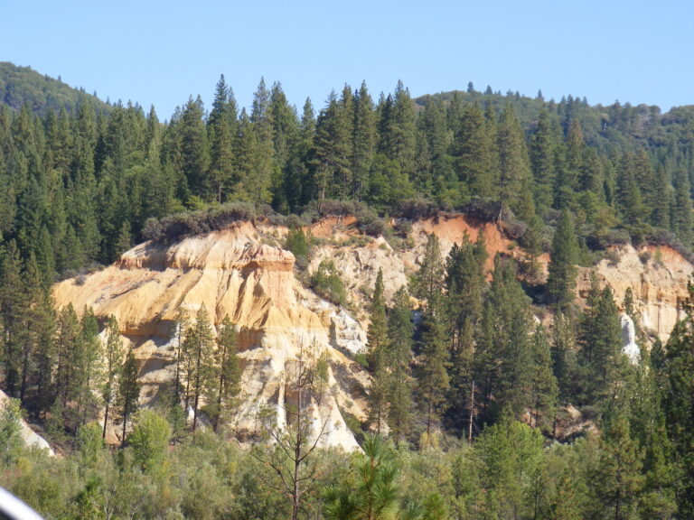 Eroded gold and pink hydraulic mining cliffs at Malakoff Diggins State Historic Park, North Bloomfield, California