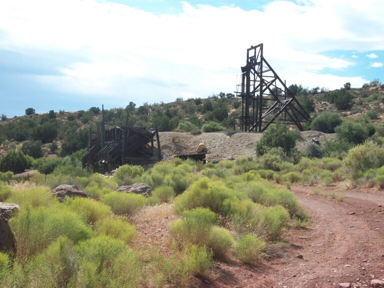 A mine head-frame standing over the red-sandstone benches at Silver Reef, Utah.